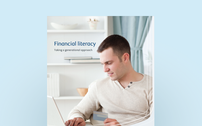 Cover of the financial literacy guide with a young man on his laptop.