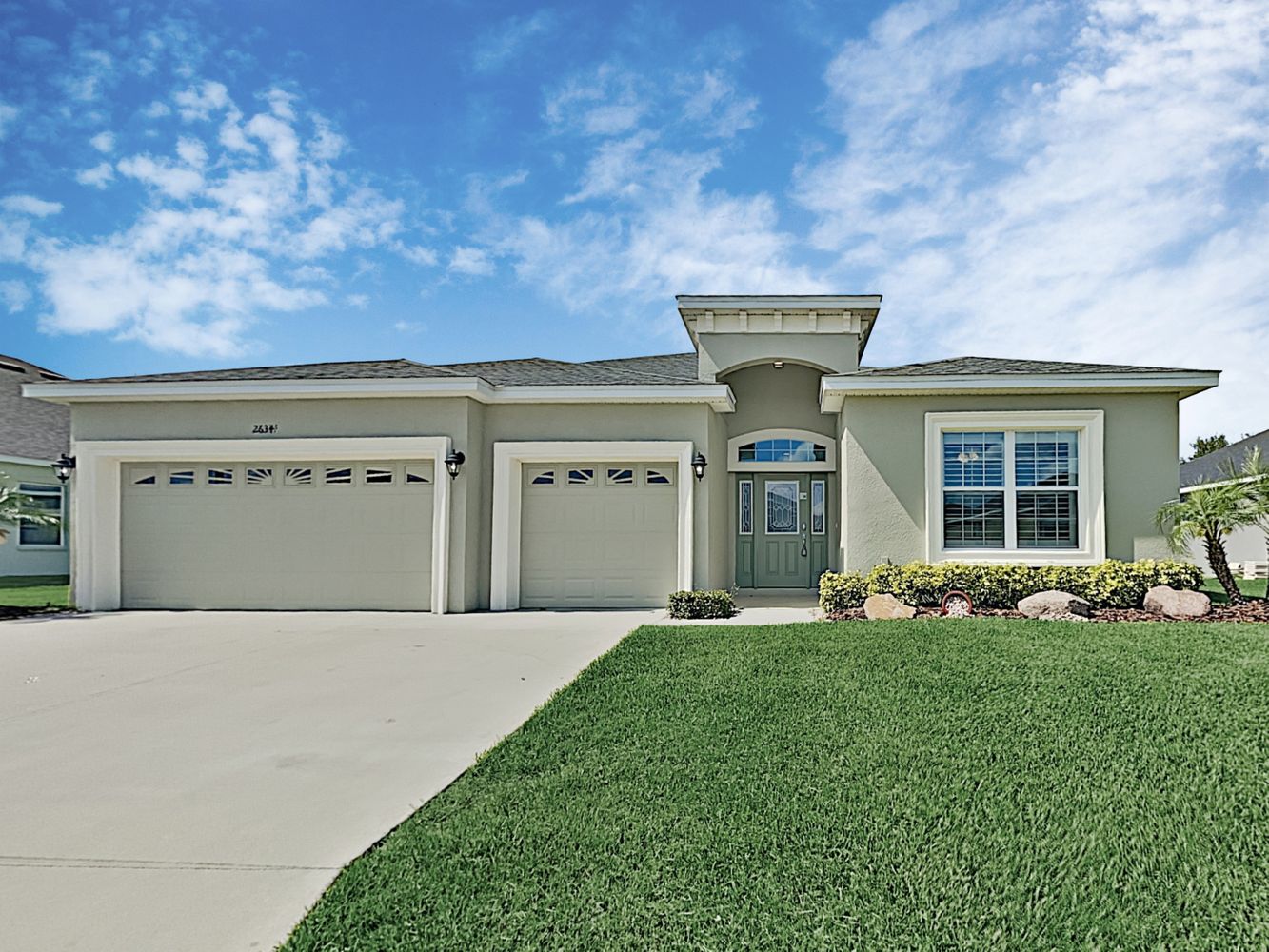 Front of house with three-car garage at Invitation Homes Tampa.