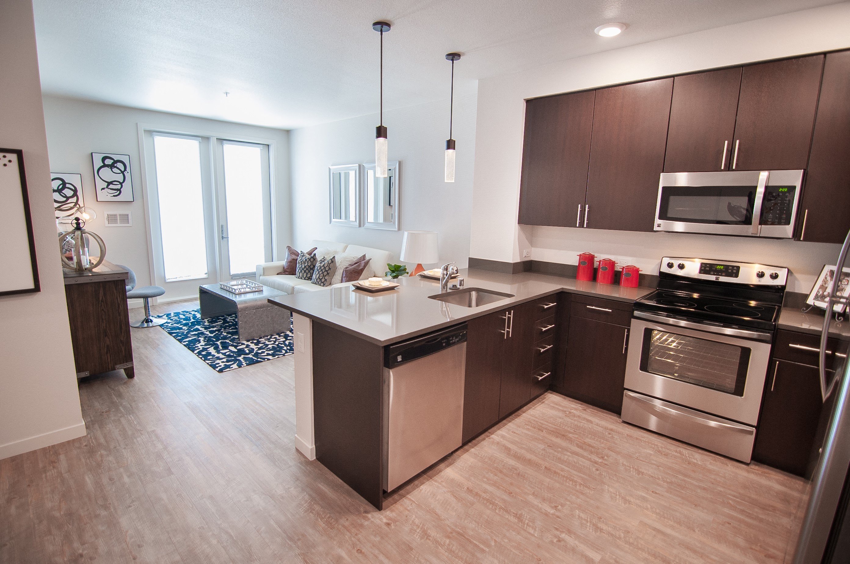 A modern kitchen with a large island and stainless steel appliances.