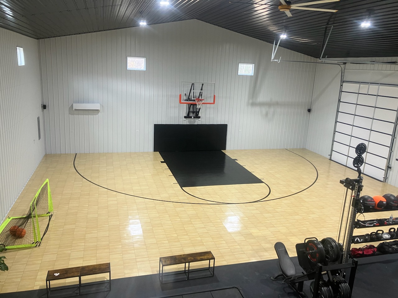 Home gym with integrated basketball half-court.