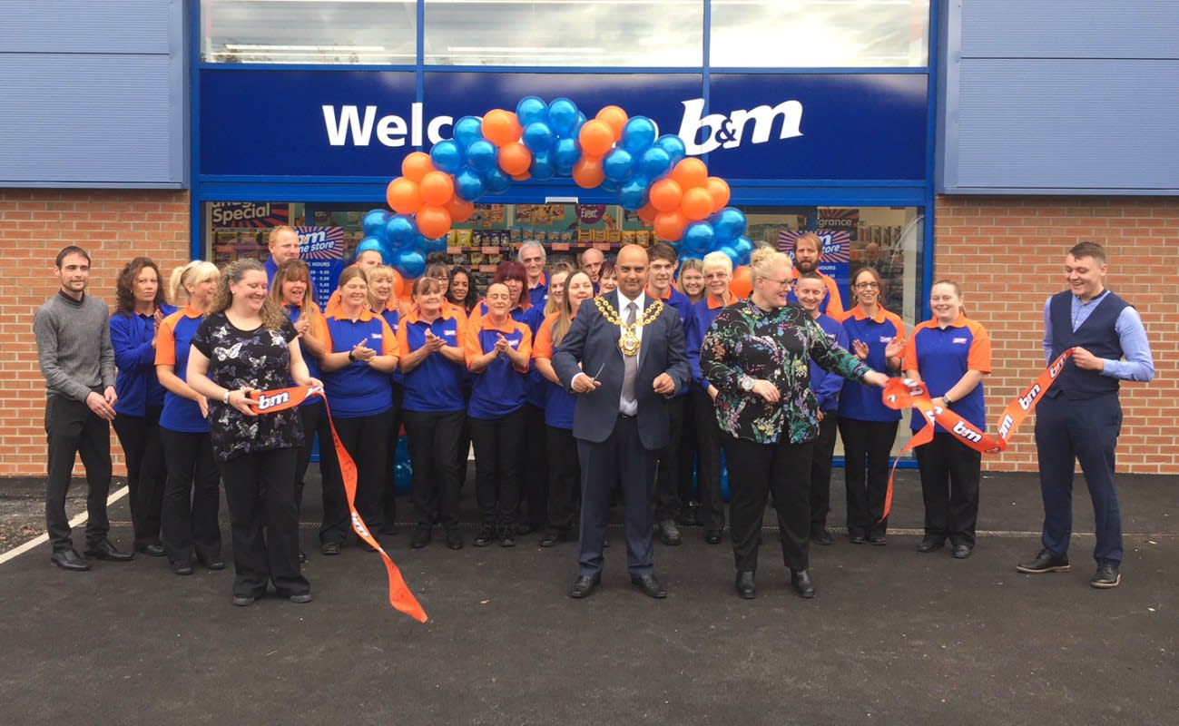 Local Mayor, Councillor Shadab Qumer cuts the ribbon to officially announce B&M's relocated Chadderton store 'open'.