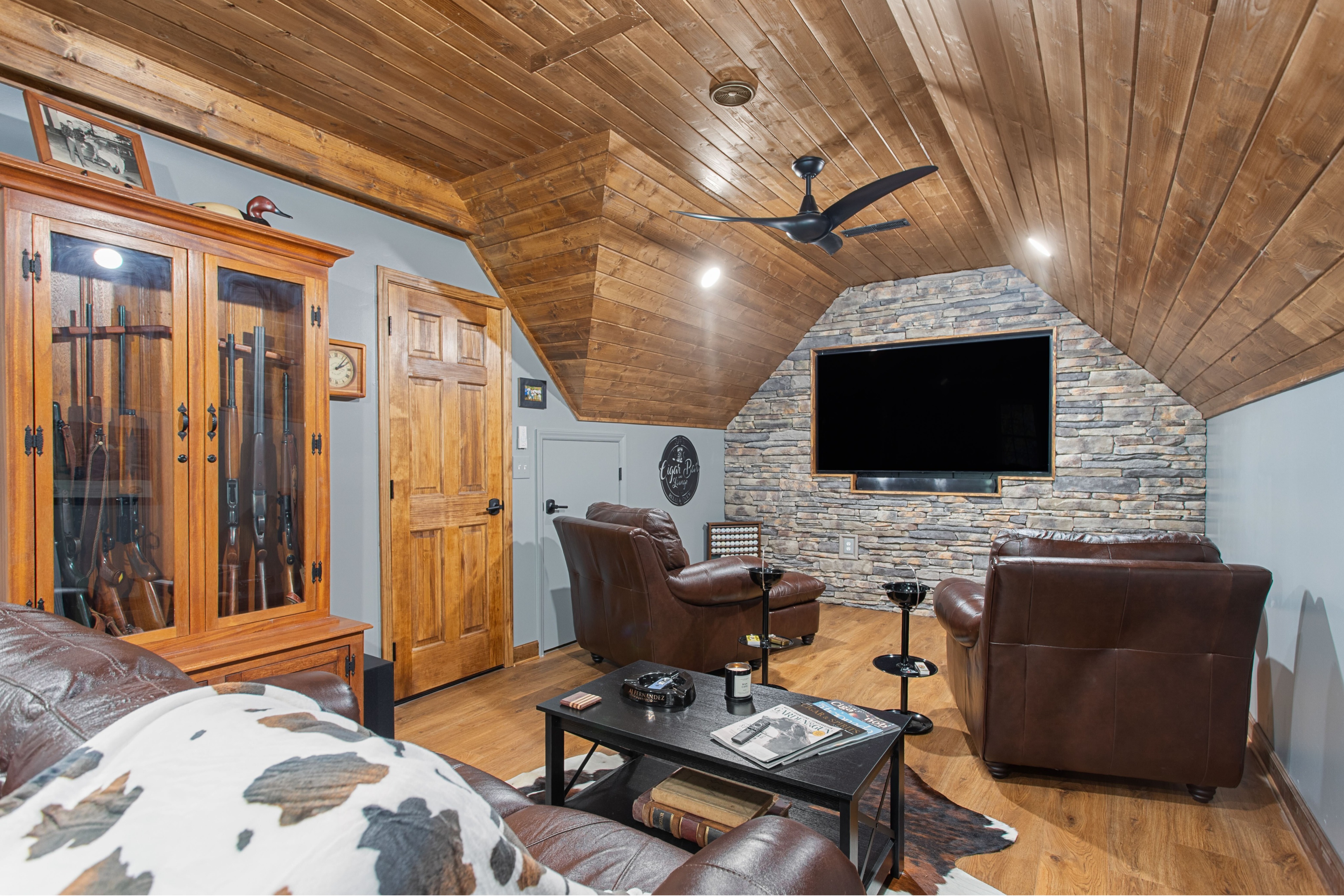 Luxury finished living space in Central North Carolina with a custom wood ceiling, built-in cabinets, and modern lighting. Designed and built by an experienced residential contractor specializing in custom home construction and remodeling.