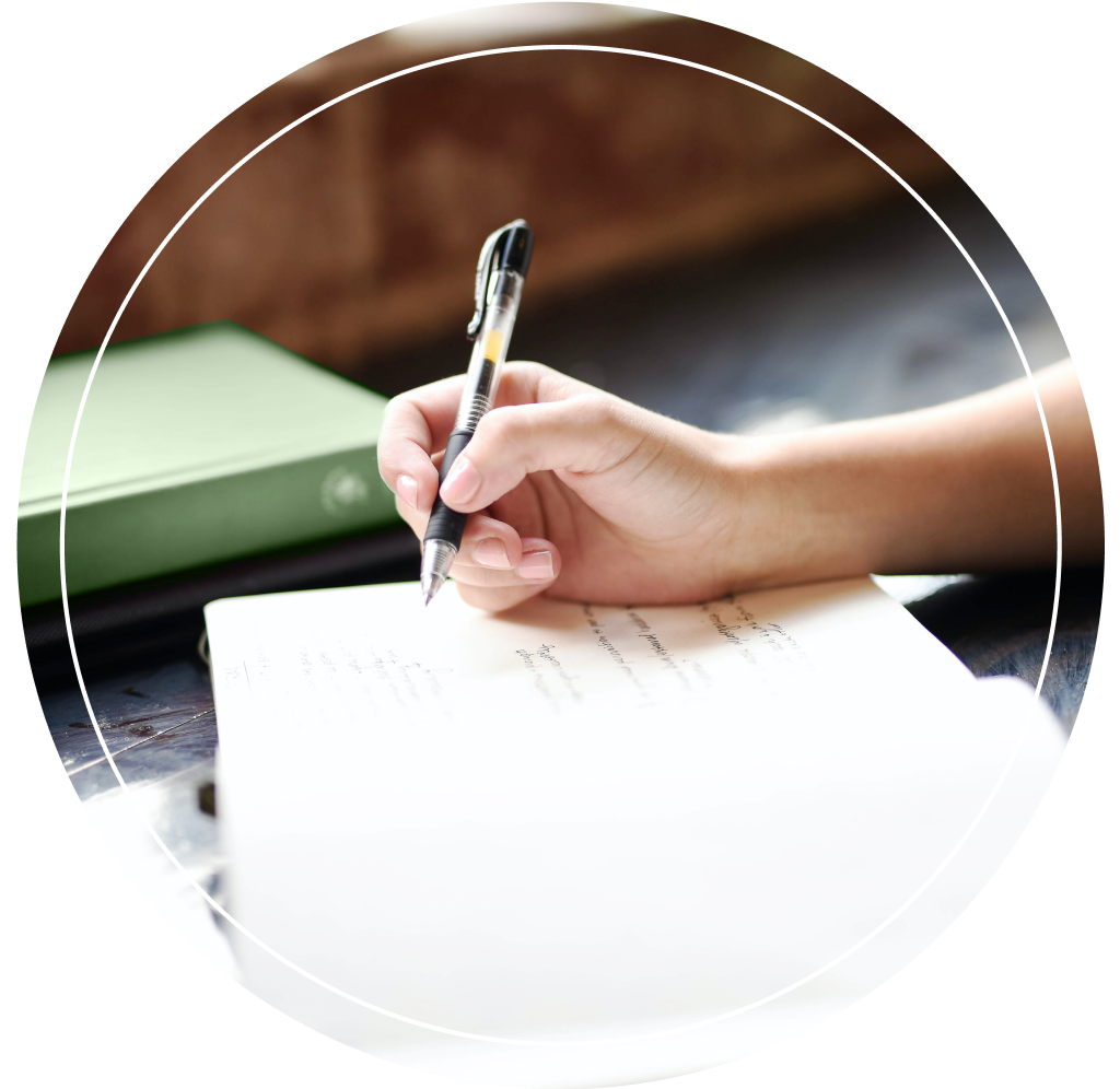 An individual writing in a journal.