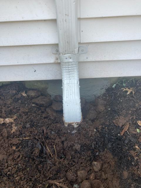Our handyman travelled to Woburn for this outside job. Today we put on an elbow in the gutter and downspout and added a drain in the ground. We also cemented the foundation to prevent leaks going into the basement.