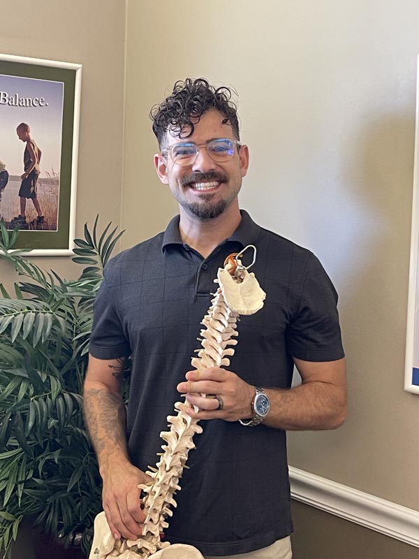 Dr. Coy holding a plastic spine