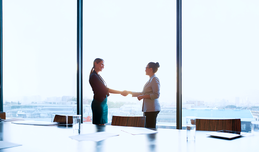 People shaking hands in an office.