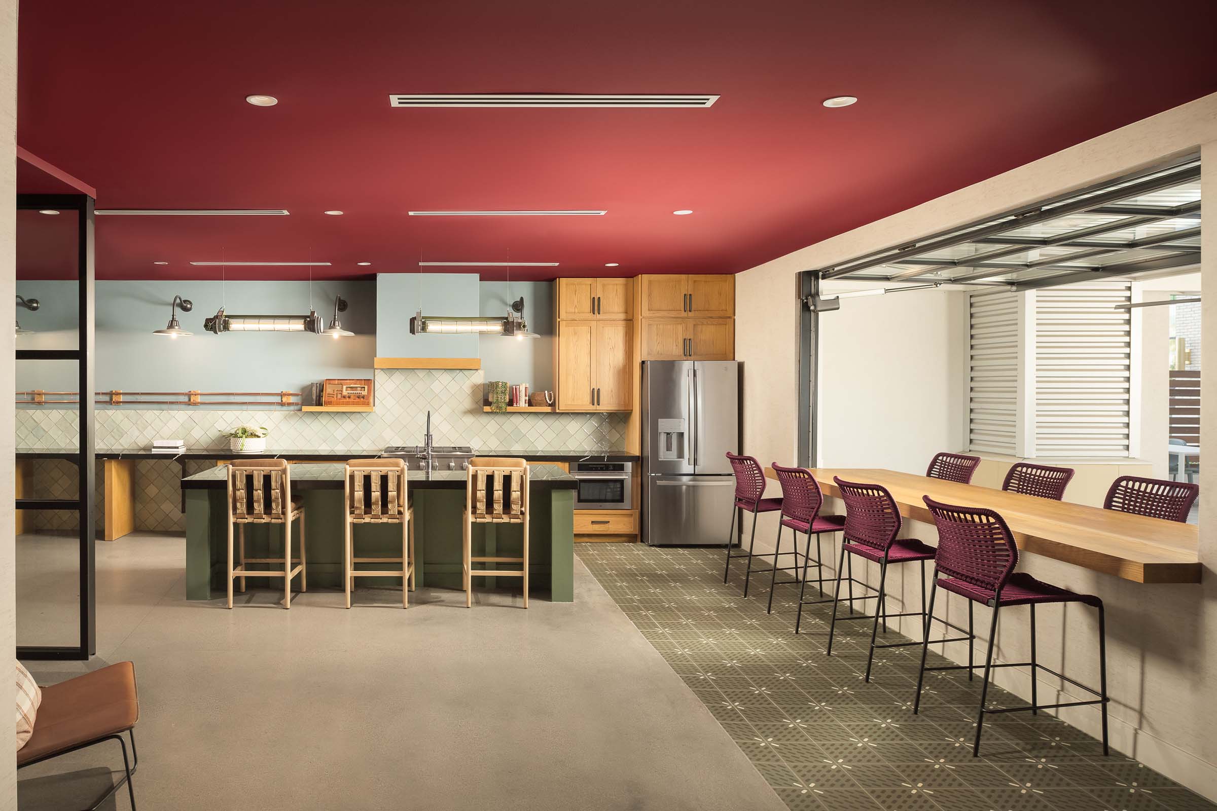 Makers lounge with garage window and kitchen at Camden Gilbert apartment homes in Gilbert, AZ