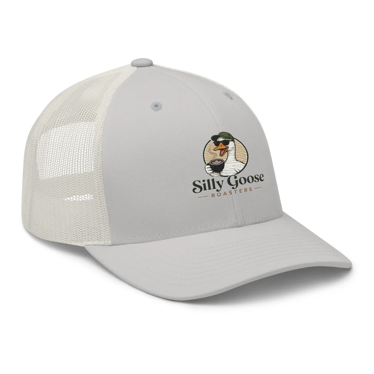 A light gray trucker hat with a mesh back is shown against a white background. The hat features a circular logo on the front that depicts a cartoon goose wearing sunglasses and a green cap, holding a cup of coffee. The text "Silly Goose ROASTERS" is printed below the graphic.