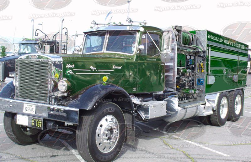 Vintage green Specialized Service & Repair heavy-duty truck with chrome grille, large wheels, side equipment compartments, hoses, and polished metal details displayed outdoors in a promotional vehicle photograph setting prominently.