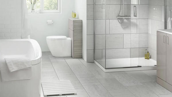 Large light wall and floor tiles in a bright modern bathroom