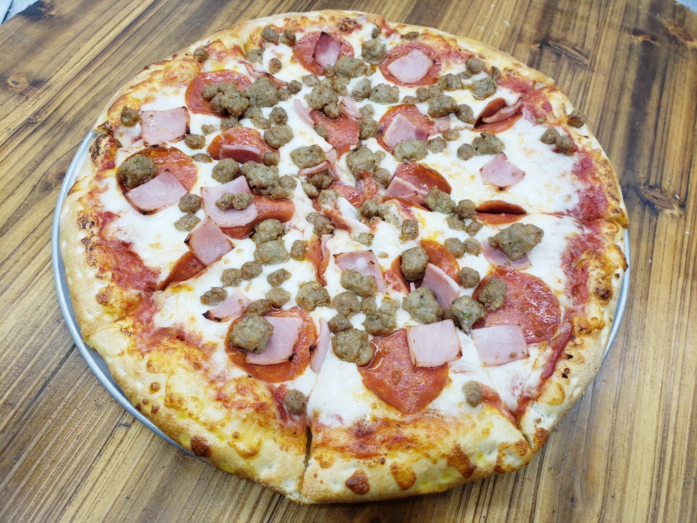 Floridino's carnivore pizza, perfectly topped and ready to be enjoyed. A meat lovers dream of a pizza right here in the heart of Chandler.