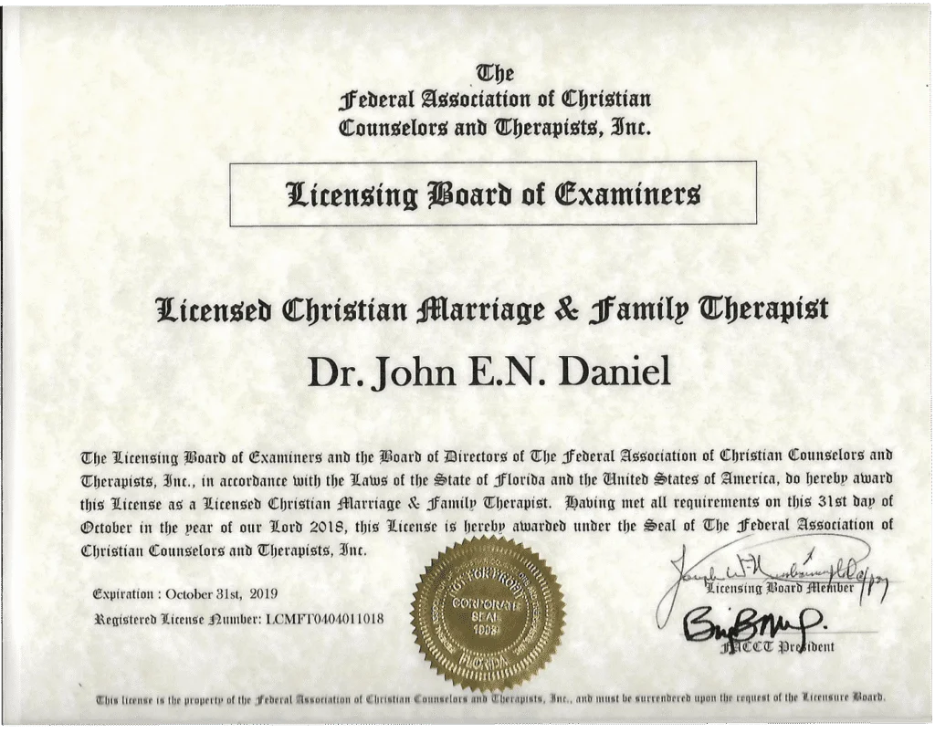 This is a certificate awarded to Dr. John E.N. Daniel for being a Licensed Christian Marriage & Family Therapist. The certificate is issued by The Federal Association of Christian Counselors and Therapists, Inc., through its Licensing Board of Examiners. The license is dated October 31, 2018, and expires on October 31, 2019. The certificate features the seal of the organization, a signature of a Licensing Board Member, and the signature of the NACC President. The background has a textured, parchment-like appearance, and the border has a light blue watermark.