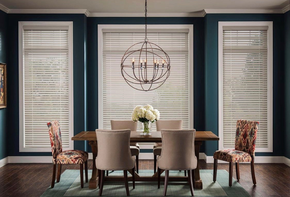 Our team at Budget Blinds of Rockwall, Terrell, and Greenville love the contrast of Faux Wood Blinds with an accent wall for a clean and fresh look. Budget Blinds of Rockwall, Forney, Terrell, and Greenville can help update your space.