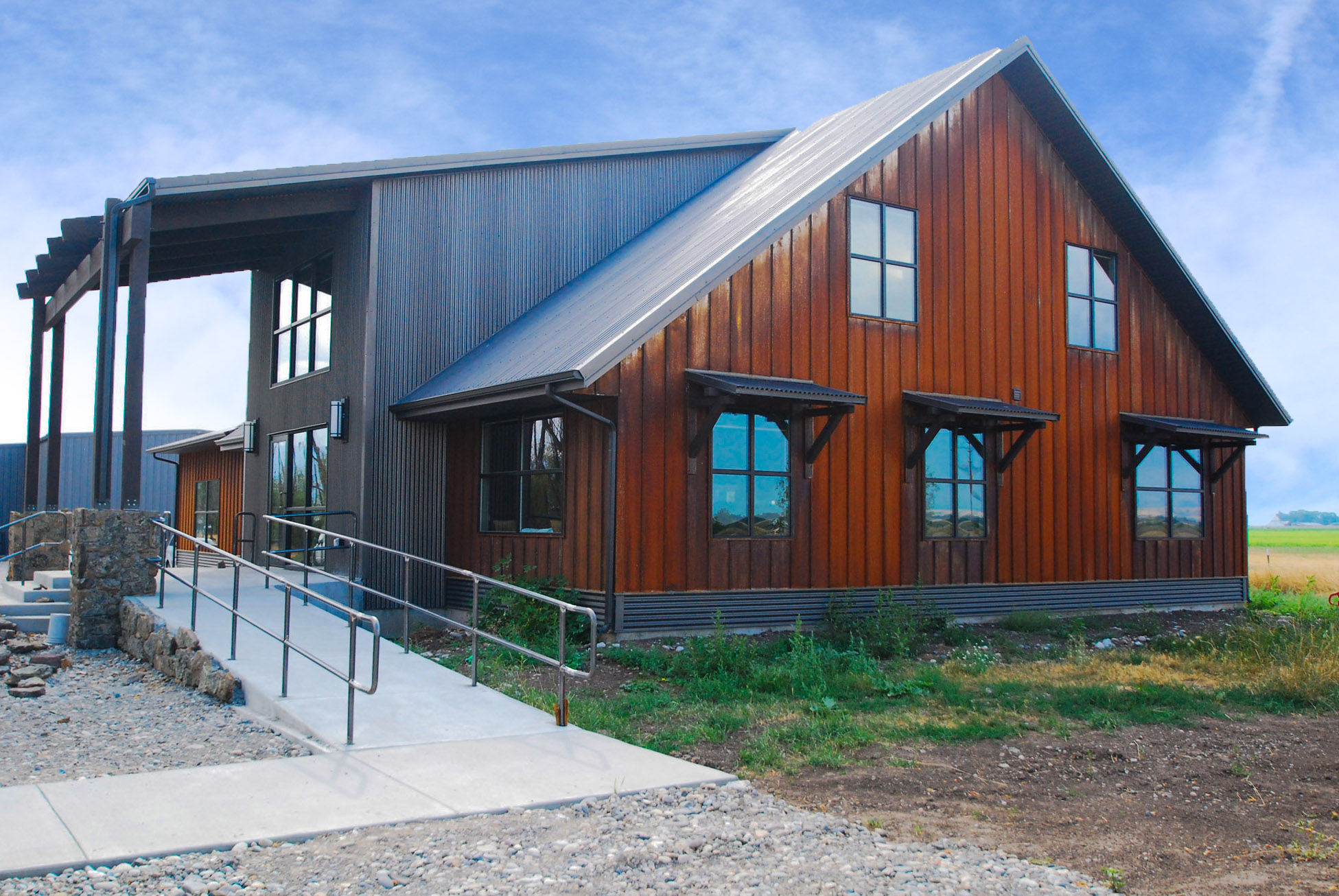 Residential structure built with metal siding and roofing materials, offering strength, low maintenance, and versatile design options.