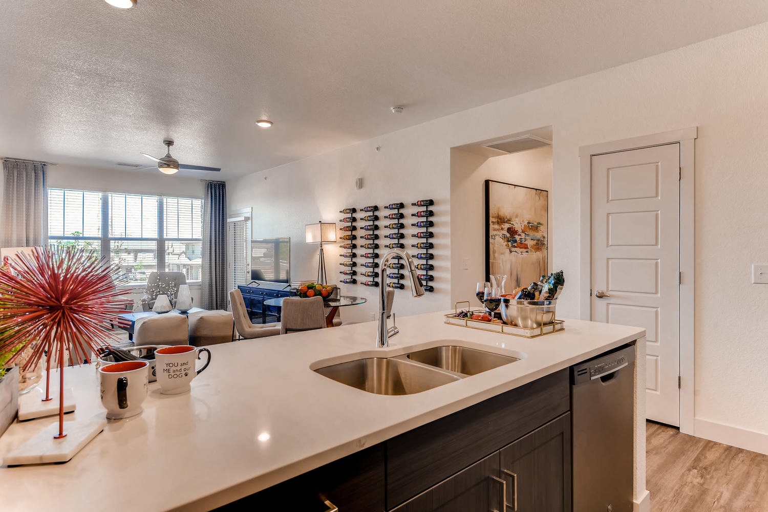 A modern kitchen with a large island and a dining area in the background