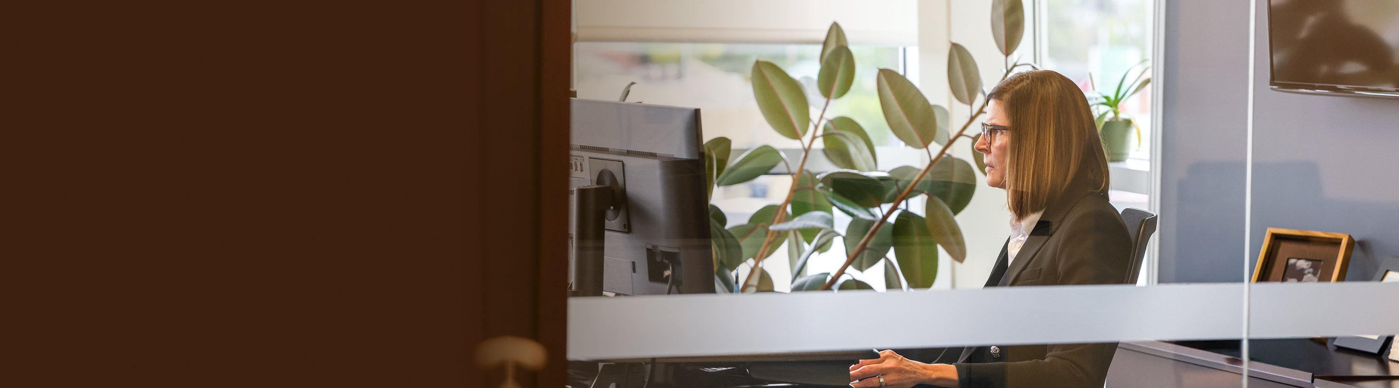 Kathy Dion engaged in focused work in her office.