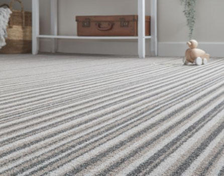 A striped carpet in a living room area