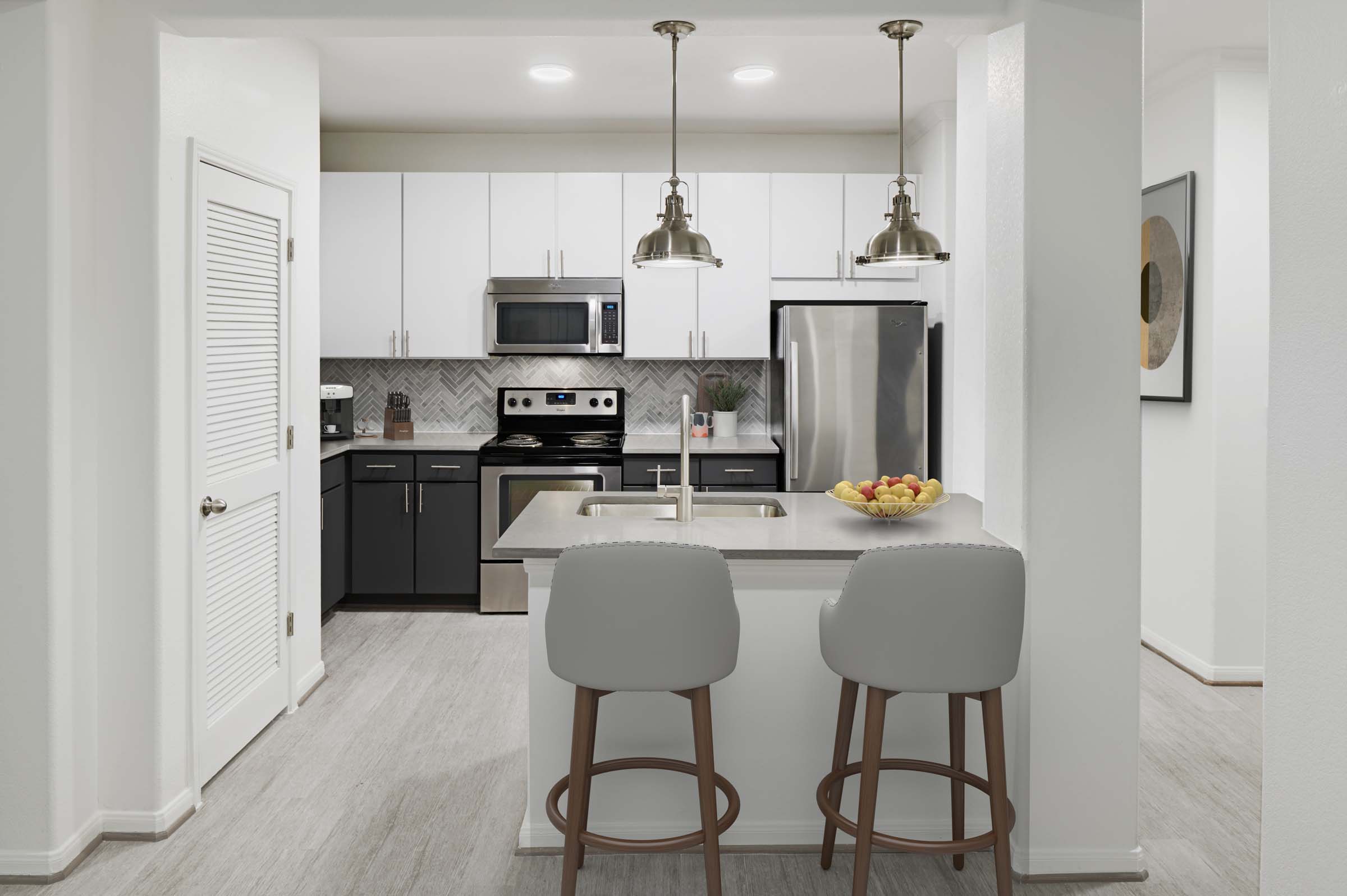 Kitchen with stainless steel appliances and quartz countertops at Camden Heights apartments in Houston, TX