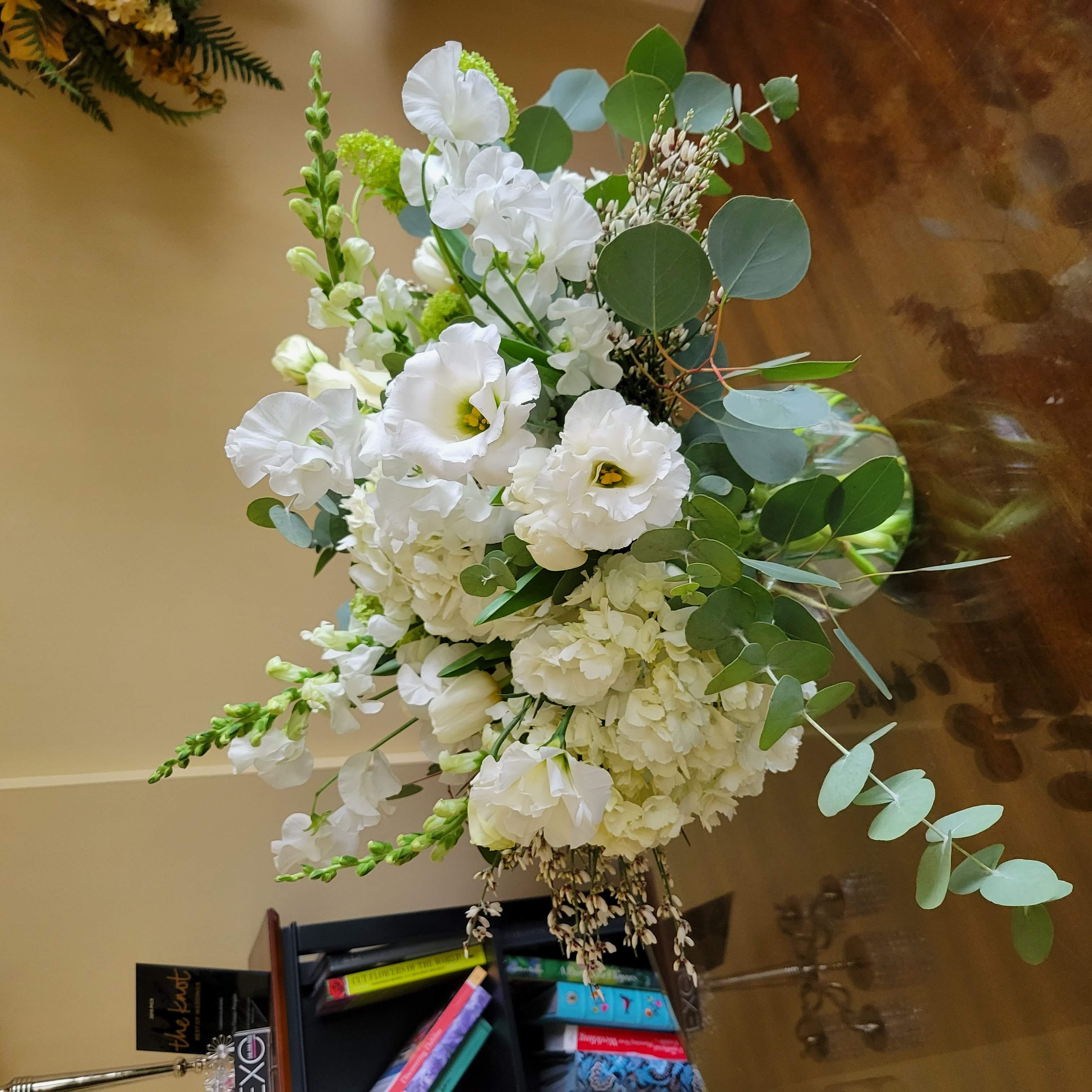 Neutral spring arrangement with lisianthus, hydrangea, tulips, sweet peas, and eucalyptus