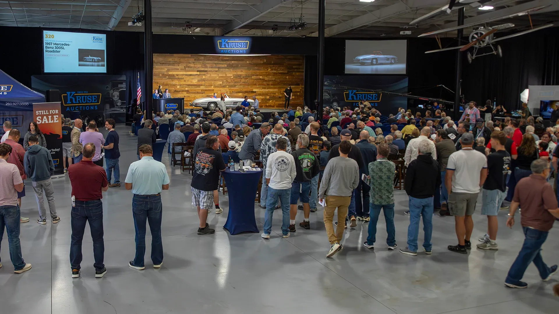 Live Kruse Auctions event featuring bidders, guests, and collector automobiles in Auburn, Indiana.