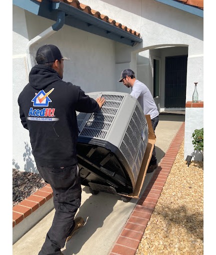 Two Aced It! Cooling & Heating technicians delivering and installing a new HVAC unit at a residential property in Corona, CA. The technicians are shown working professionally, ensuring high-quality service for a homeowner. This image showcases the company's expertise in HVAC installation and replacement services, emphasizing reliability and local trust.