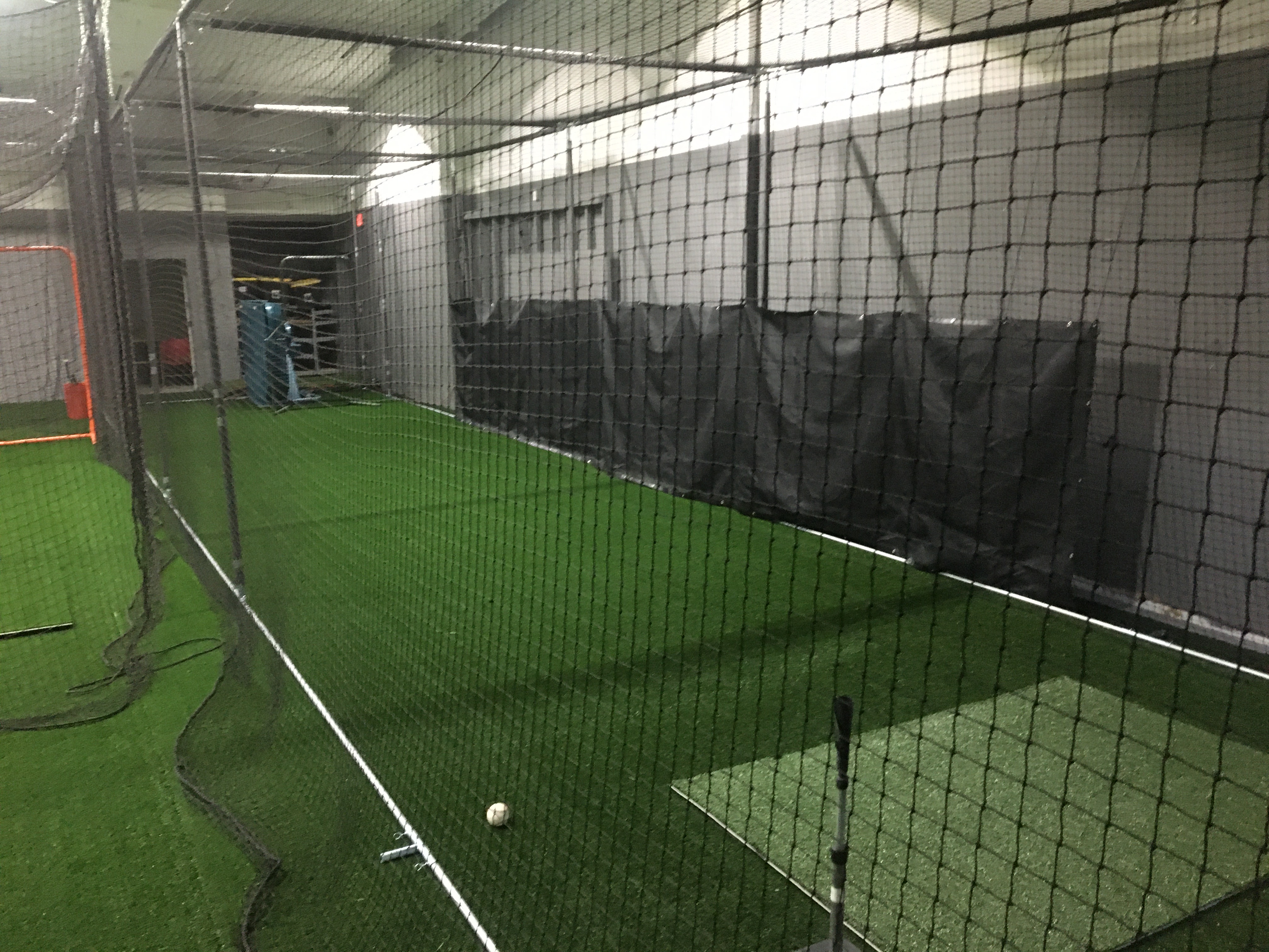 Big batting cage with pitching machine