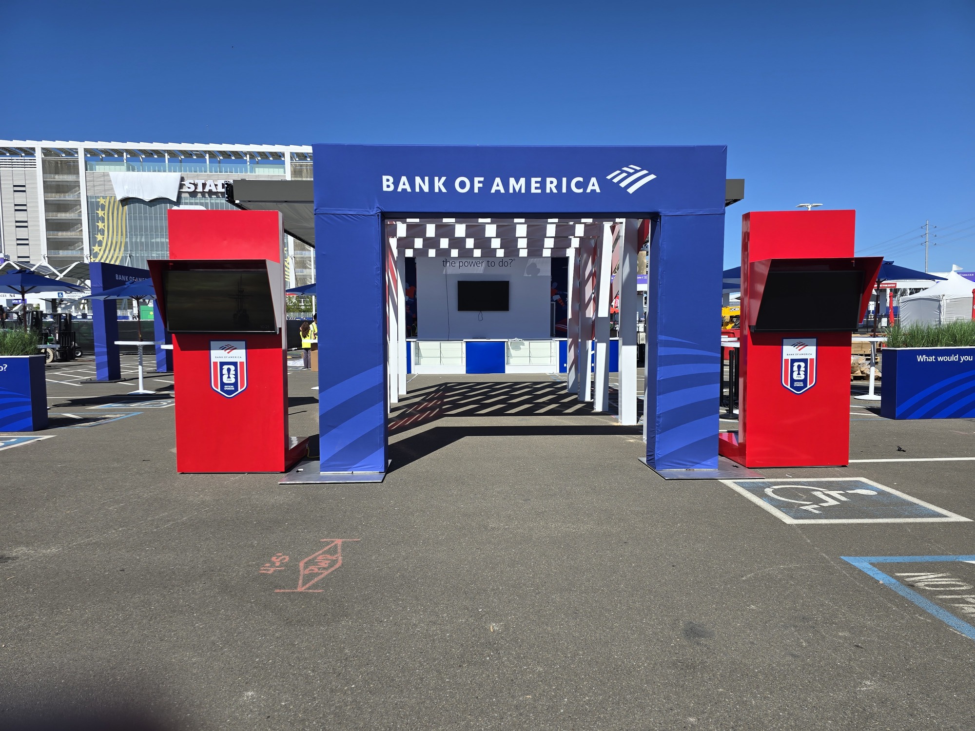 Custom red-and-white architectural exhibit structure designed as an immersive walkway within the Bank of America experiential event environment.