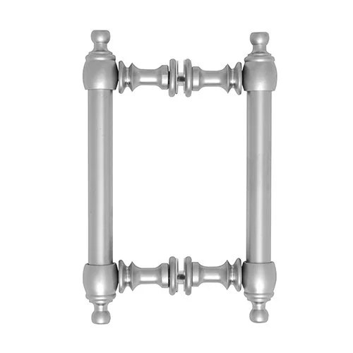 A brushed nickel colonial pull handle, featuring a rectangular shape with decorative elements. The handle has two vertical posts on either side, connected by horizontal bars with a series of beaded and grooved accents. The top and bottom of the vertical posts are capped with decorative finials, resembling small inverted urns. The handle is presented against a plain white background.
