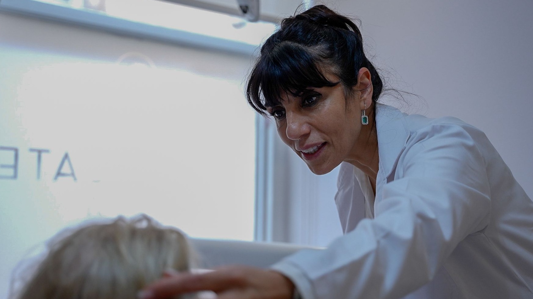 Dr. Shohreh Ghasemi, award-winning dentist and lead clinician at The Harrogate Clinic, performing a patient consultation in the clinic's treatment room in Harrogate.
