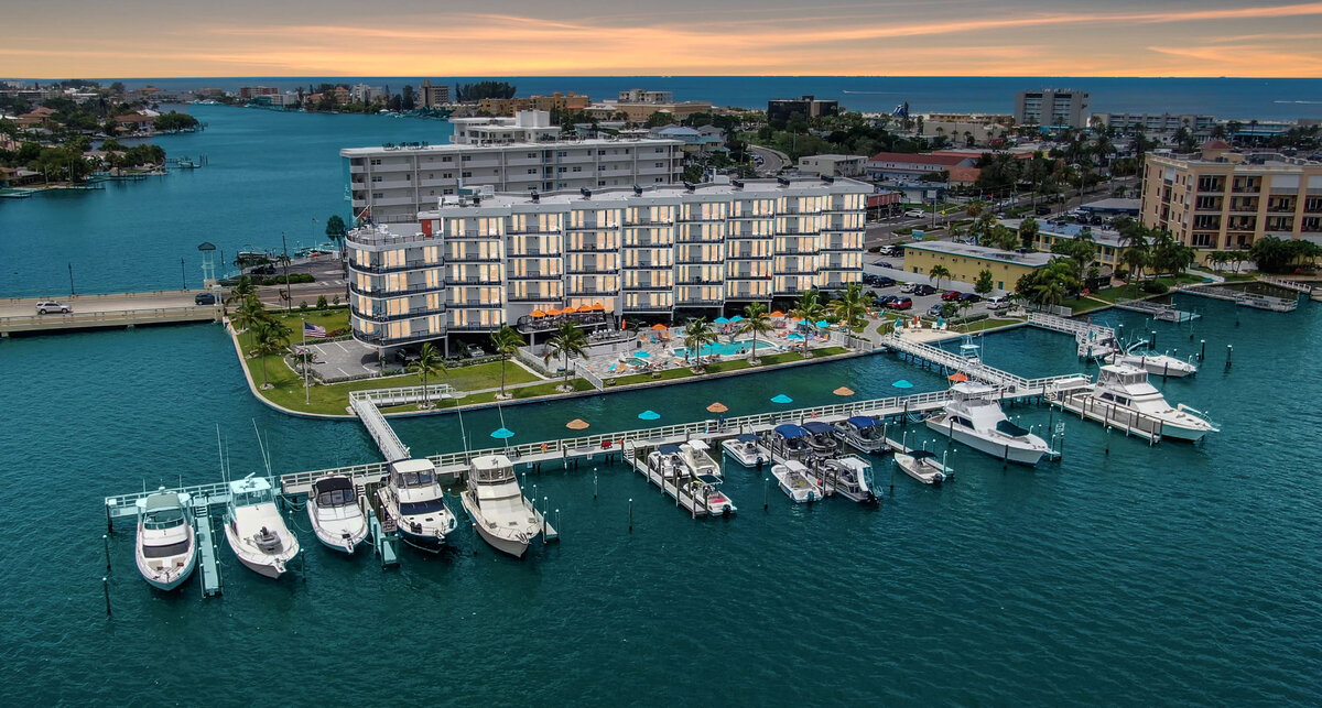 Aerial view of FUSION Resort in Treasure Island, Florida featuring waterfront suites, marina access, pool deck, and intracoastal views near St. Pete Beach.
