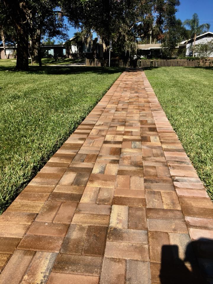 The Winter Haven home's walkway leads up to the front door and around the side extending to a dock