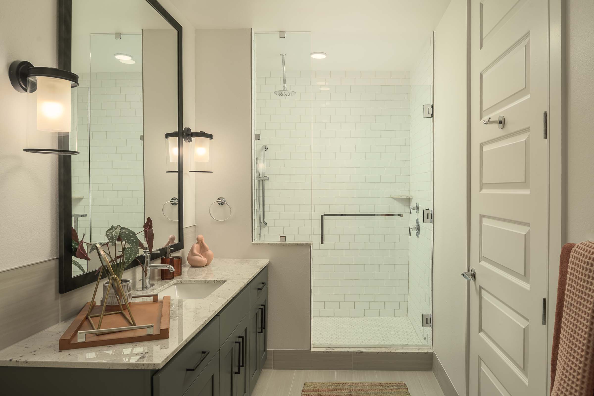 Bathroom with glass-enclosed shower with bench seat at Camden Gilbert apartment homes in Gilbert, AZ