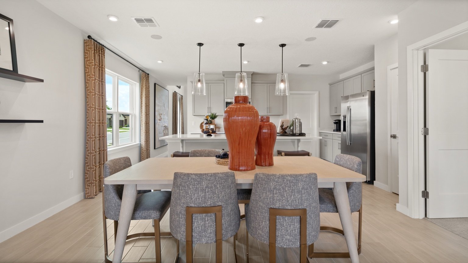 The Jupiter Model Home Open Concept Living and Dining Area at Grasslands West by DRB Homes