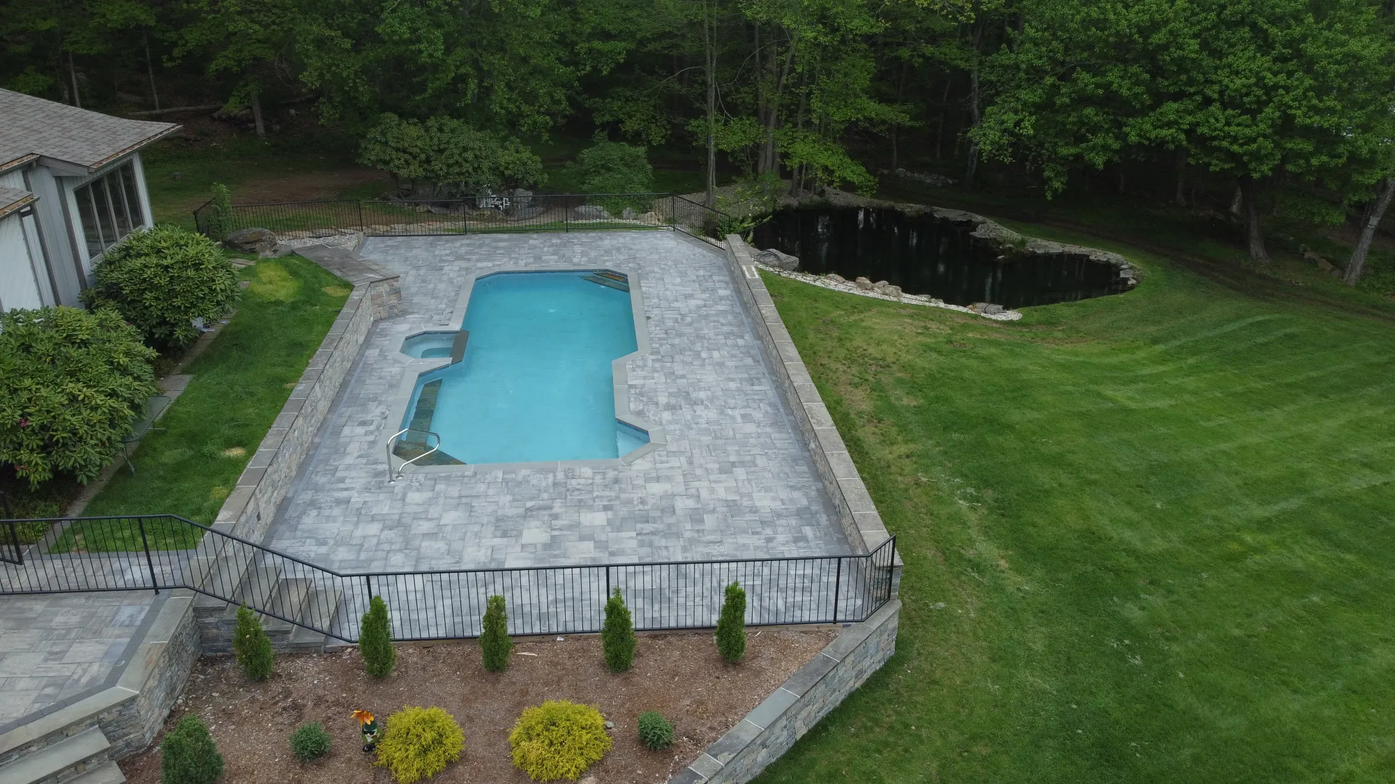 Drone view of a completed Southbury paver pool deck - Paver Pool Deck, Southbury project by General Masonry LLC.