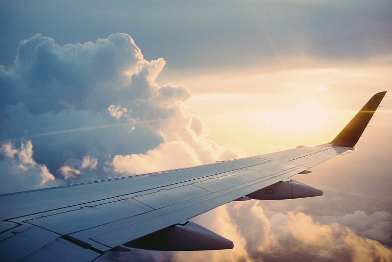 Airplane wing with clouds.