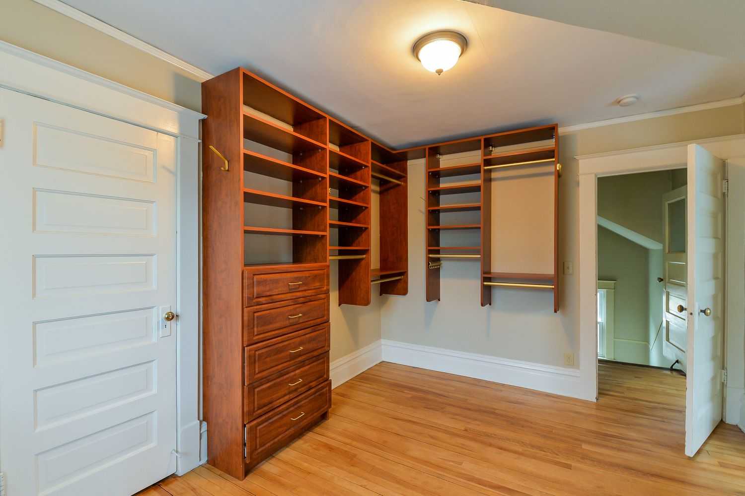 Living space with built-in shelving and wood flooring at Invitation Homes Minneapolis.