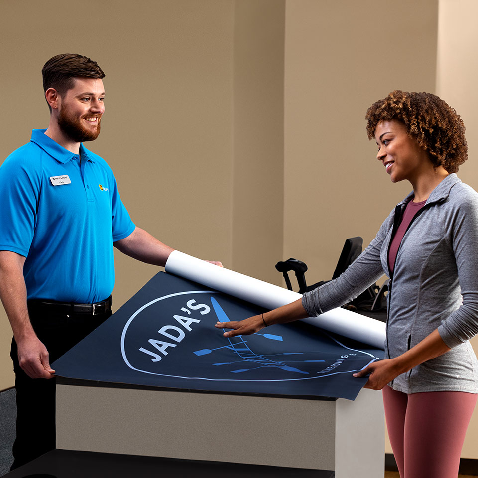 UPS Store Associate assisting with poster printing
