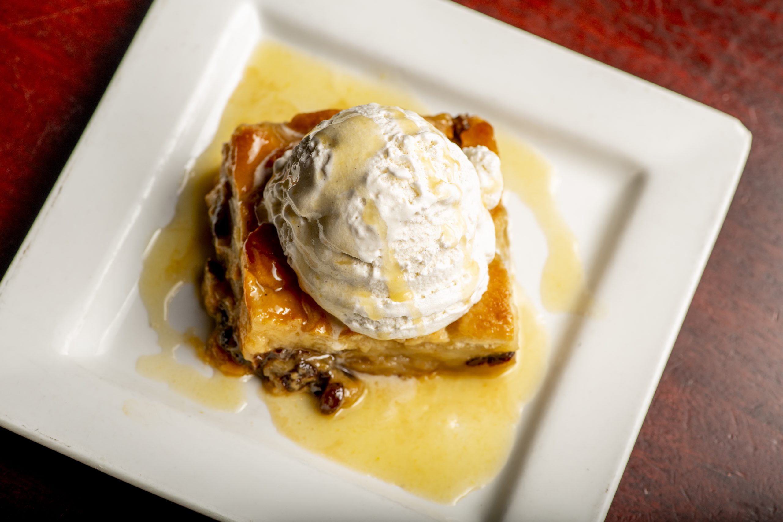 deSha&rsquo;s Bread Pudding: our custard-based bread pudding, whiskey sauce, raisins and vanilla bean ice cream