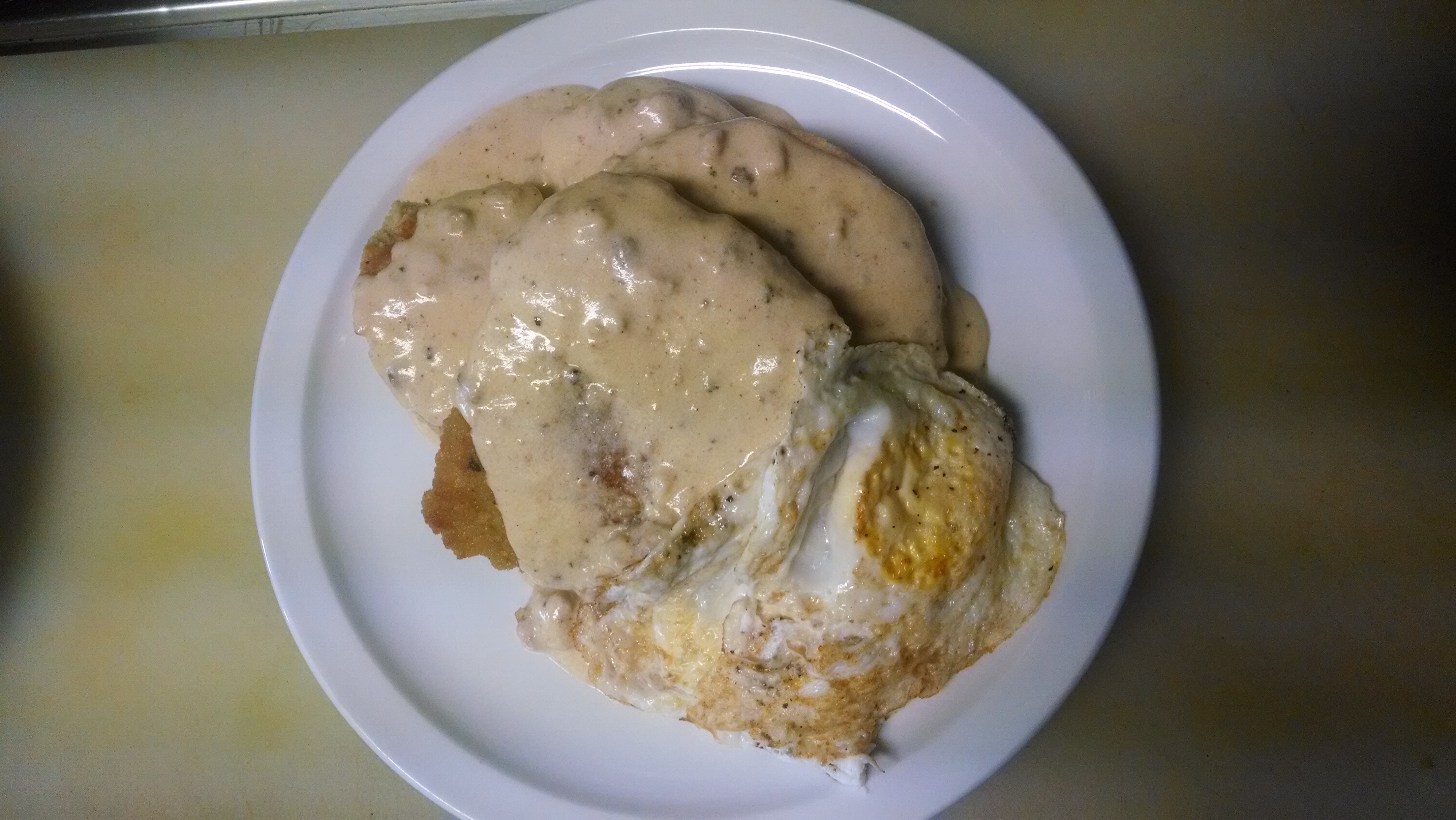 Mmmmm...The Chicken and Biscuit with 2 eggs smothered in rosemary sausage gravy.... Bare Bones Cafe & Bar Portland (503)719-7128