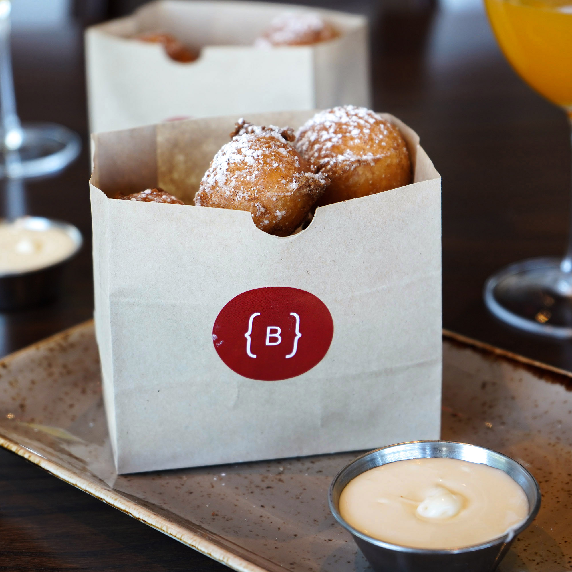 House-made baker’s dozen, cinnamon, powdered sugar, cream cheese dipping sauce.