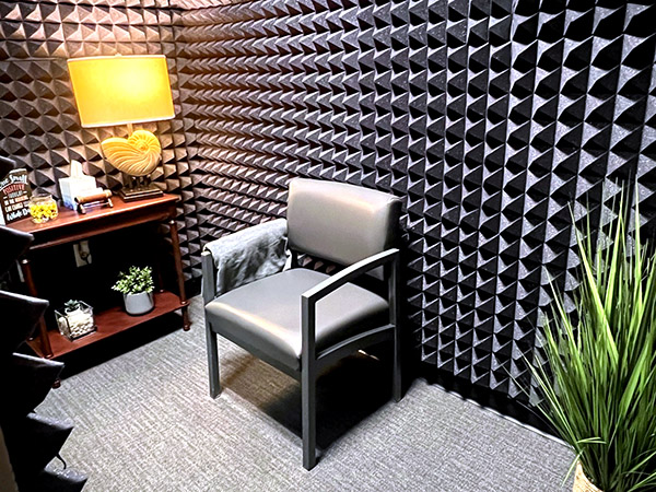 Interior photo of the hearing exam booth of AudioNova hearing clinic in Leesburg, FL