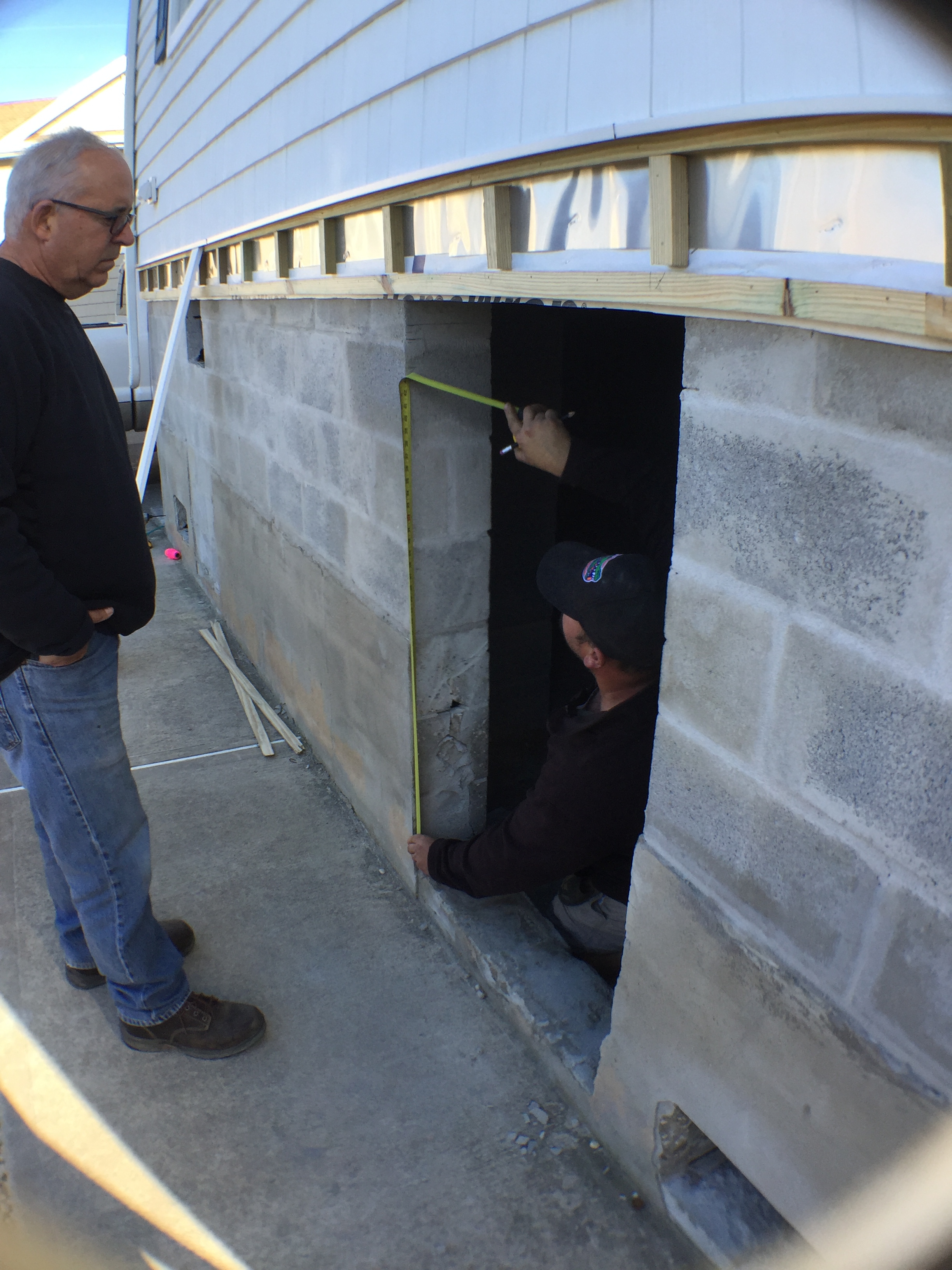 Ocean Beach Cottage - measurements for a custom door to the new storage are are taken