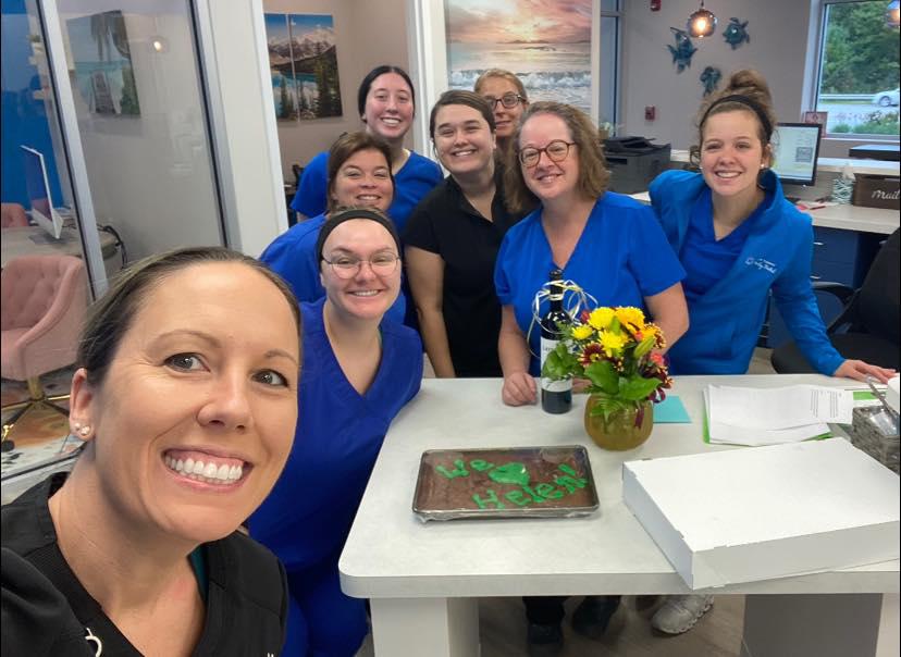 Dr. Carly Paragas & Dr. Caitlin Kompanowski share some happy moments with their team of dental professionals at Advanced Solutions Family Dental