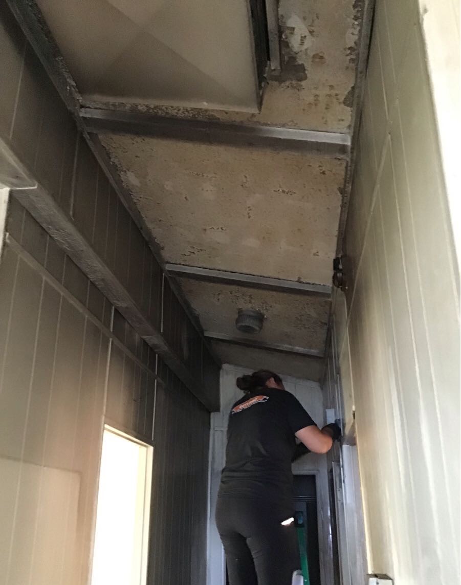 This photo shows  that the  property was burned, the smoke of the fire was impregnated in the walls, ceiling, windows, doors.. In the next photo our Professional technician is cleaning one of the walls affected.