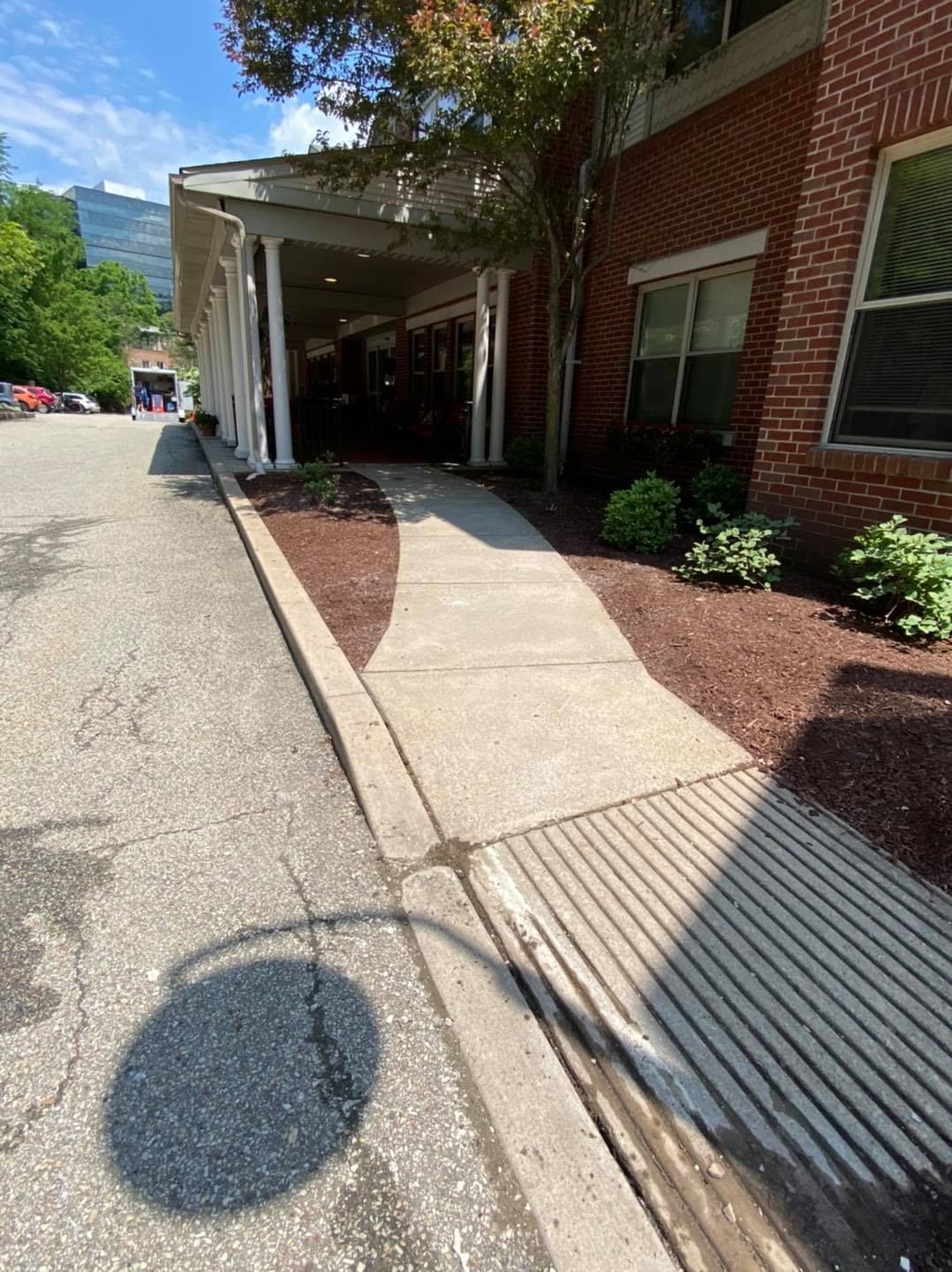 Commercial property sidewalk and curb installation featuring accessible pathways, concrete paving, and landscaped surroundings. The project demonstrates professional flatwork, curb construction, pedestrian accessibility improvements, and durable exterior infrastructure designed for safety and long-term performance.