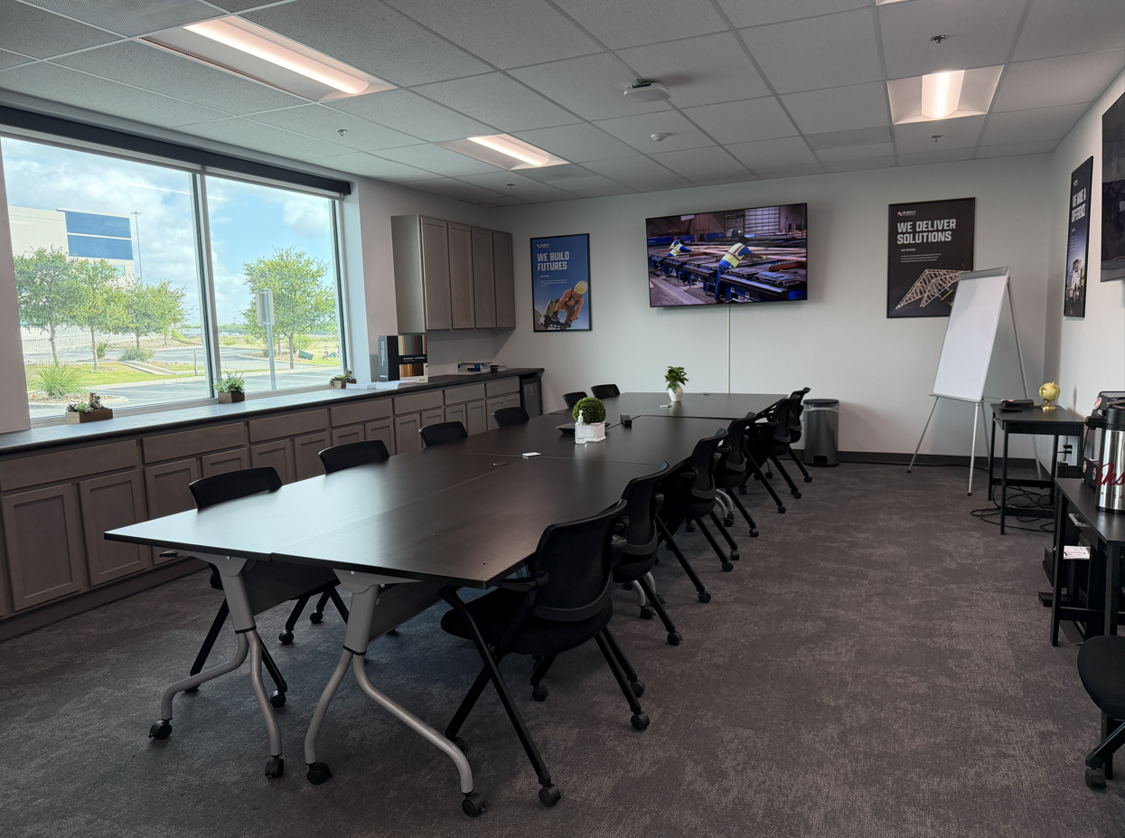 Builders FirstSource training and meeting room with conference tables, rolling chairs, presentation  