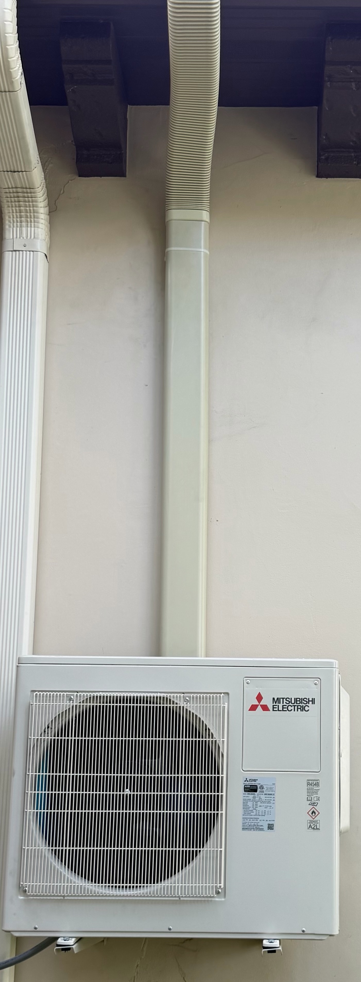Exterior ductless mini-split condenser connected to the indoor wall unit for energy-efficient climat 