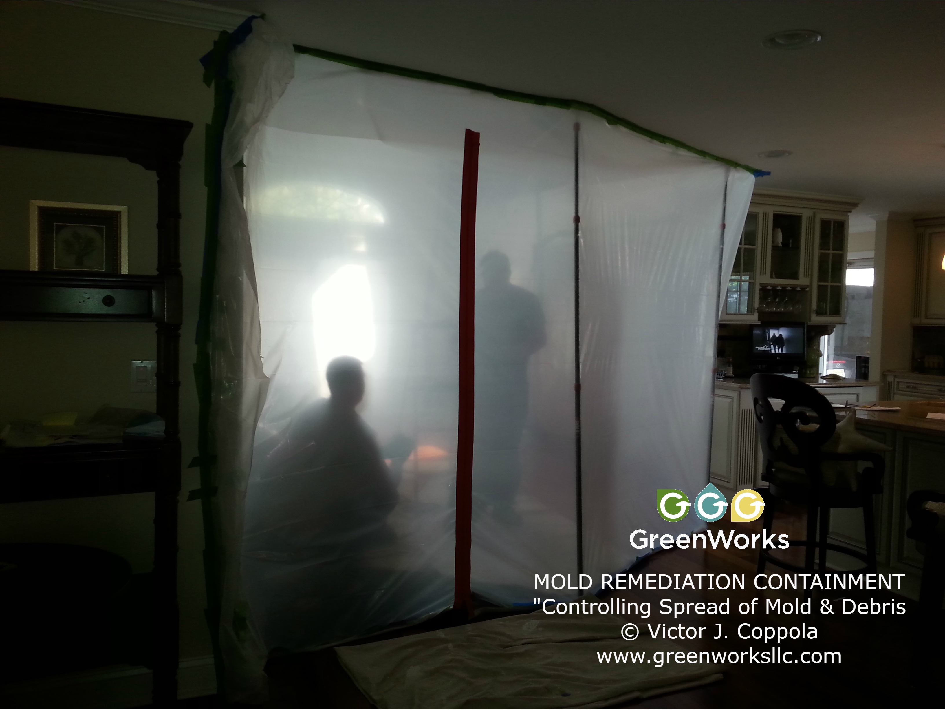 Containment setup photo showing a sealed work area used to control airborne particles during mold remediation.
