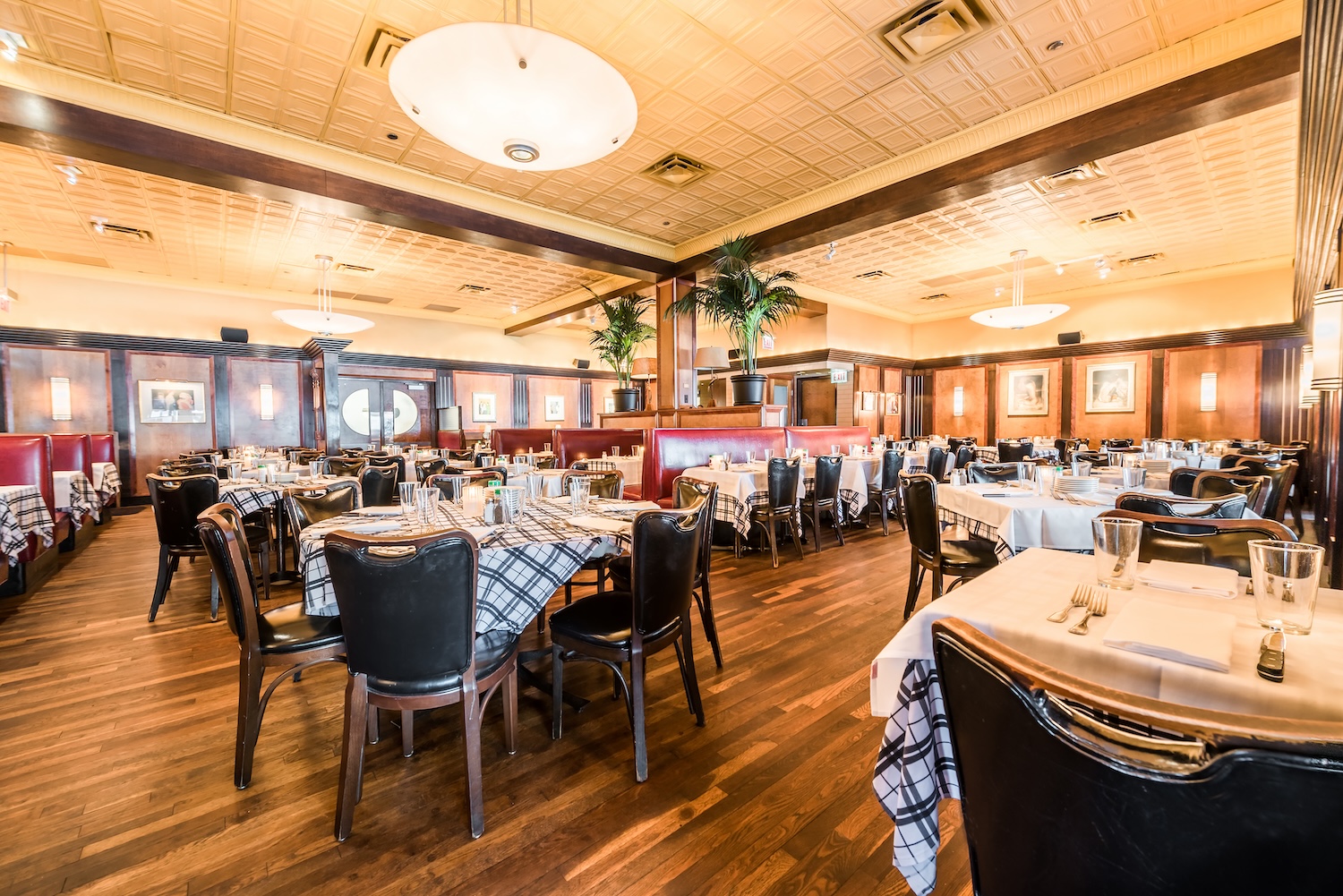 The warm, inviting interior of Gibsons Bar & Steakhouse in Chicago features classic wood-paneled wal 