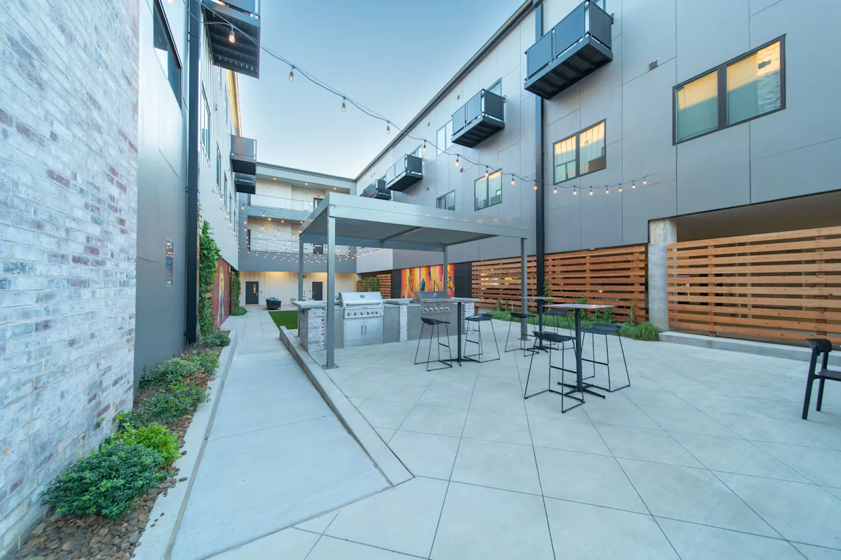 A Patio Area With Table and Chairs at G at Market Apartments, Bentonville, AR